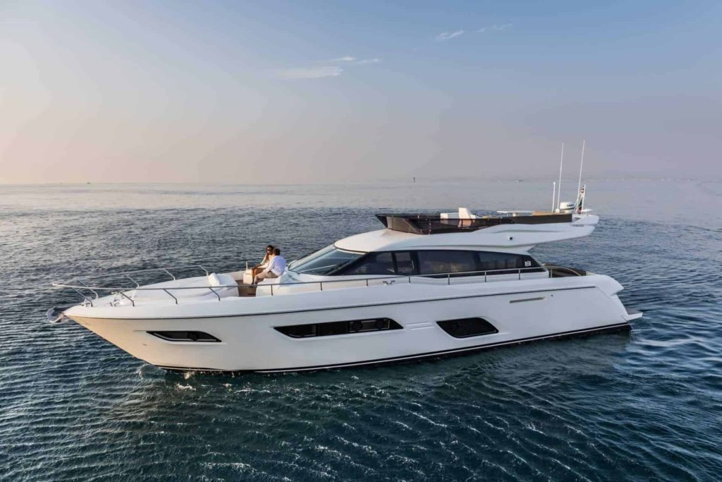 This is a photograph of a Ferretti 550 with a happy couple