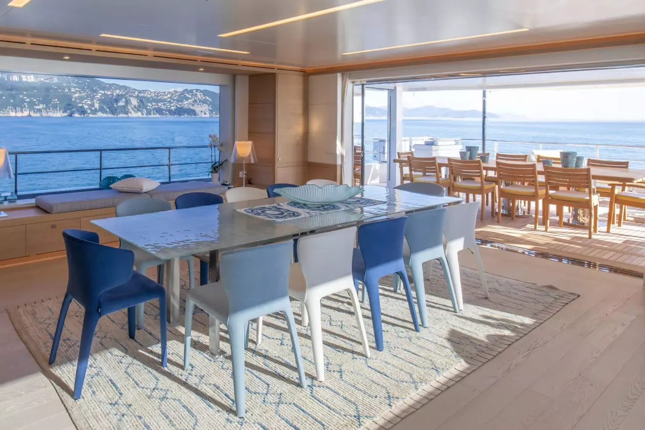 'Mat' yacht's formal dining area with panoramic views from large windows.