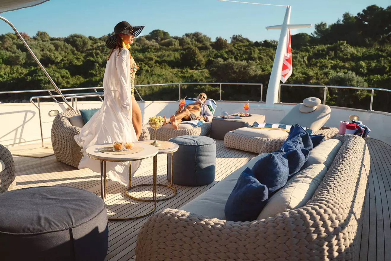 People lounging on a yacht deck, showcasing the relaxation and leisure activities.