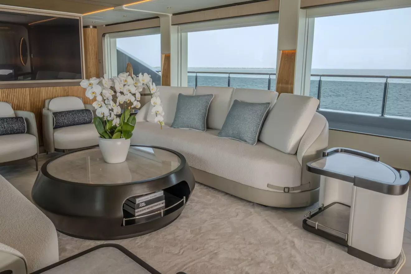 Main salon on Majesty 145 featuring light wood ceiling details and large windows