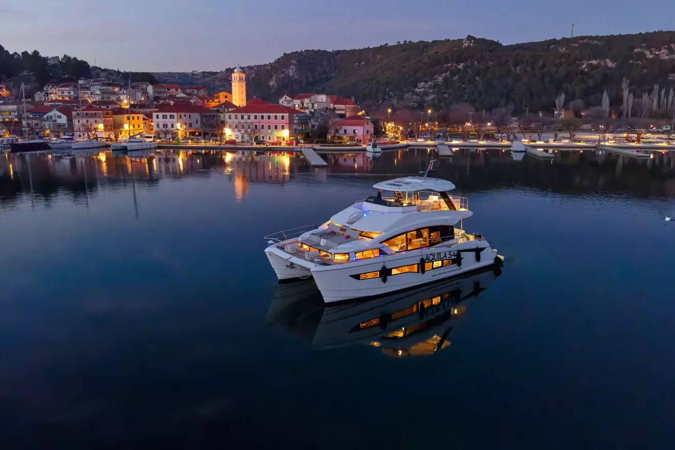 Luxury power cataman for charter, By My Side, anchored into sunset at Adriatic