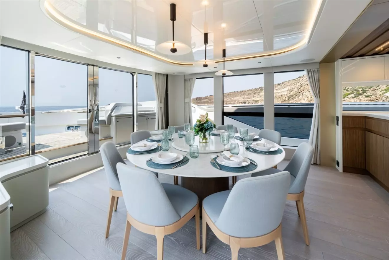 Modern dining area on the main deck of Sunseeker Ocean 82 yacht, positioned near the forward panoramic windows