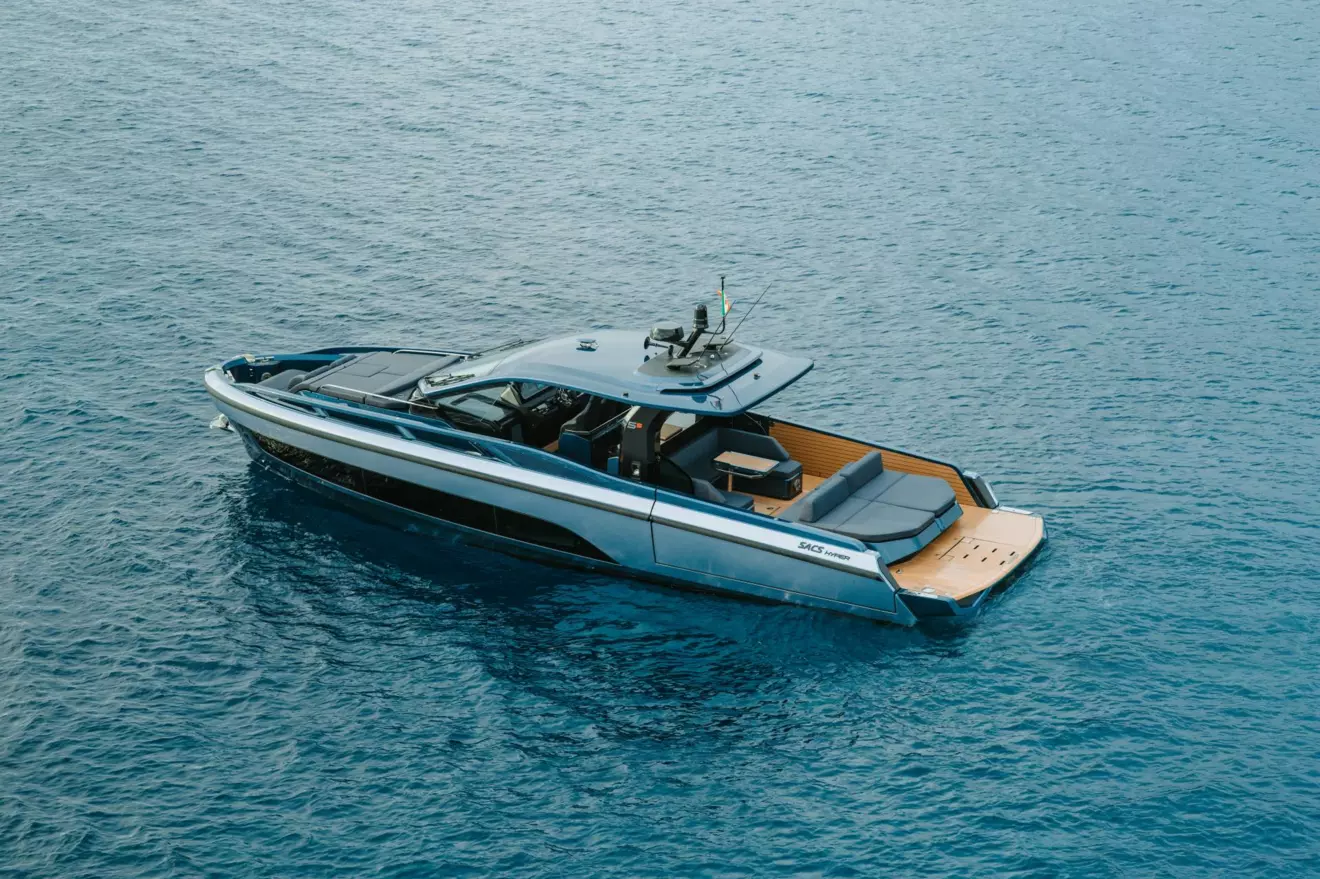 erial view of the SACS Hyper 5S anchored on clear blue water showing the full deck layout