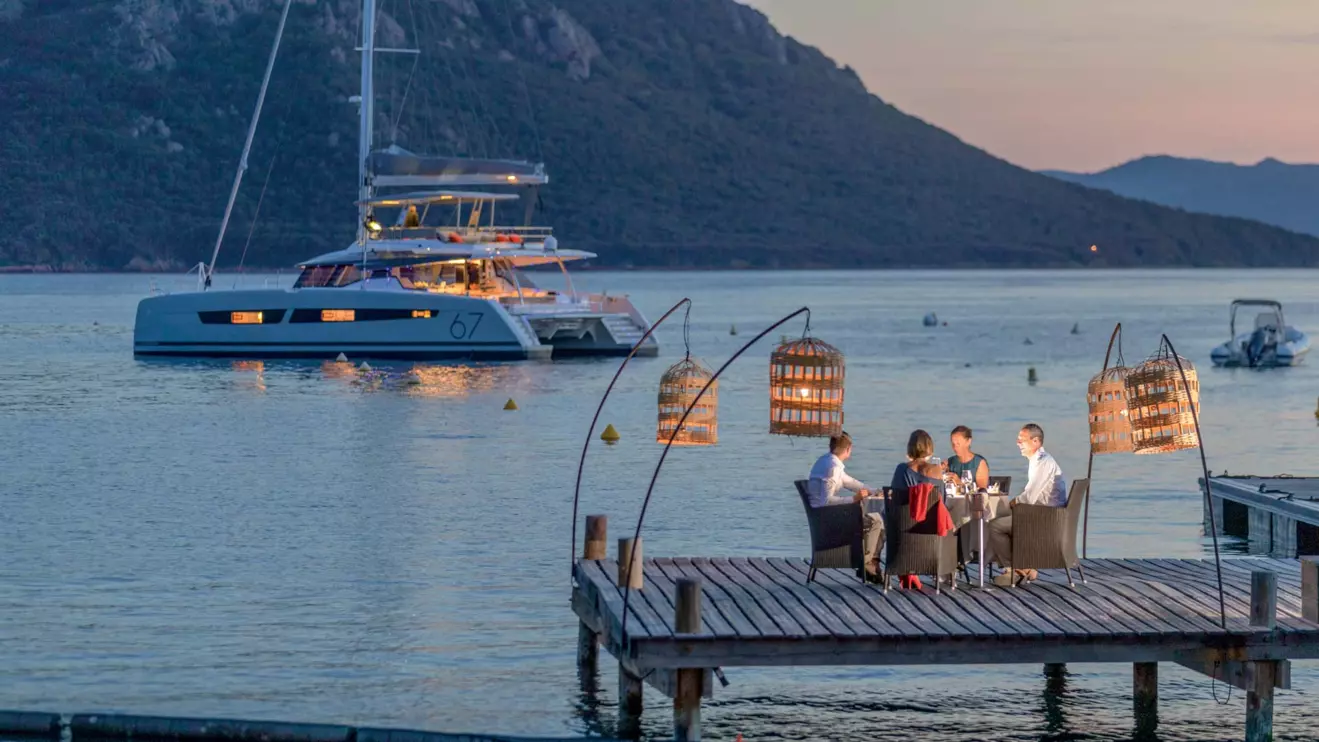 A luxurious Fountaine Pajot Alegria 67 catamaran moored in a picturesque location.