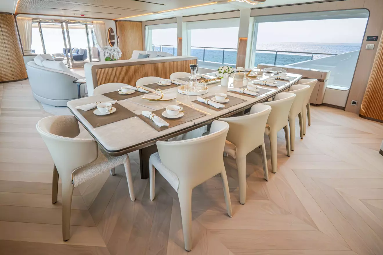 Indoor dining area seating twelve guests inside Majesty 145 main salon
