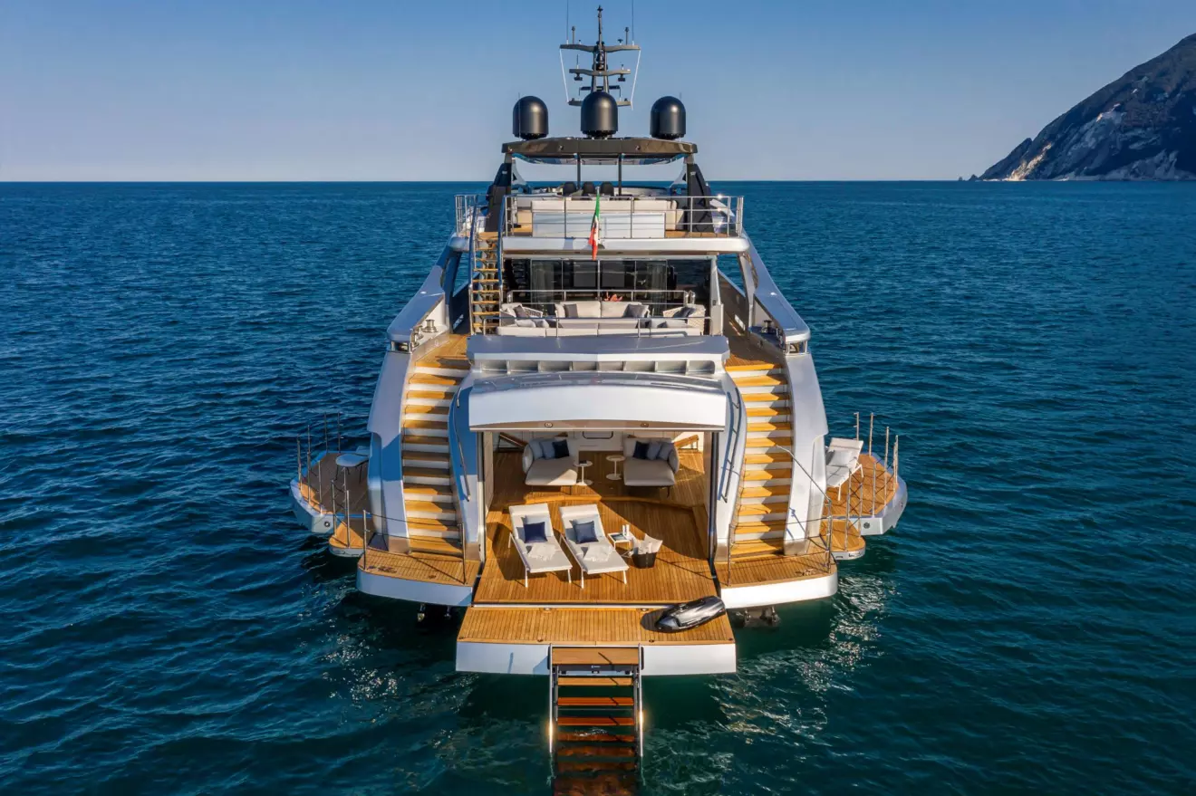 A high-angle, rear view of a luxury superyacht, the Pershing 140