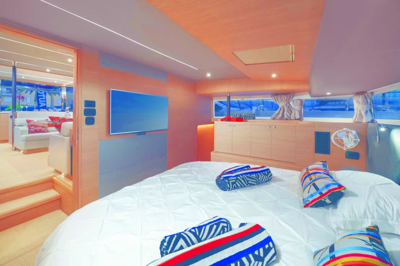 Master cabin of the Aquila 54 catamaran, with a king-size bed and panoramic windows.