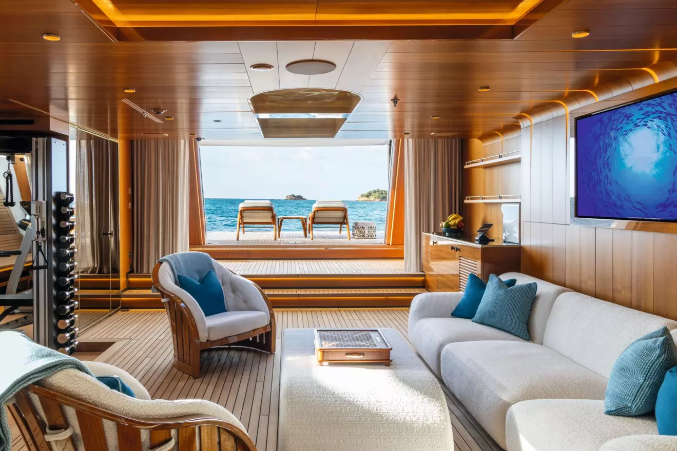 The beach club on the lower deck of M/Y Amor &agrave; Vida featuring fold-down terraces, a wellness spa, and a fitness area at the water's edge