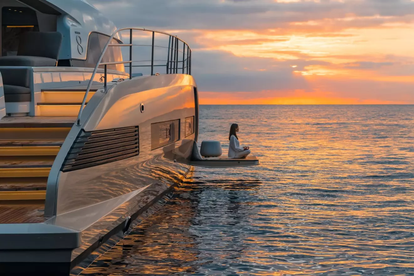 Luxury power Lagoon Seventy 8 catamaran at anchor in a calm bay at sunset.