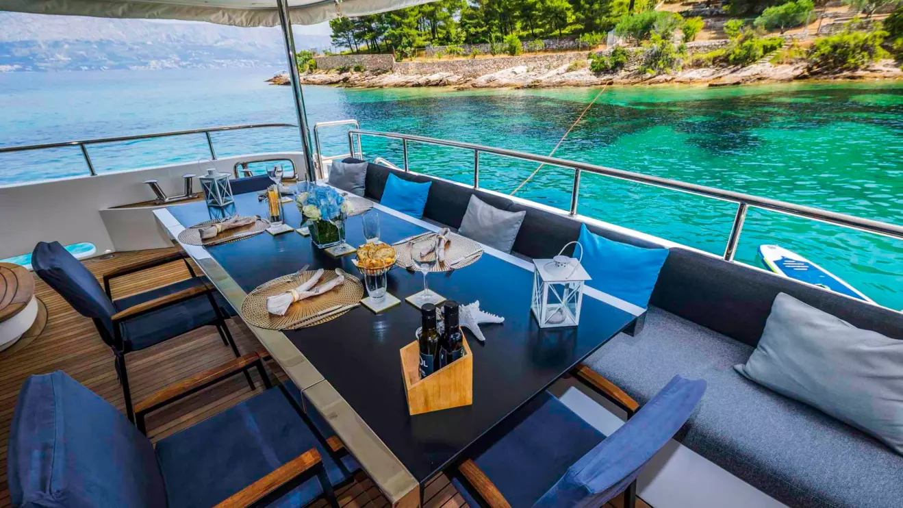 Beautifully designed al fresco dining area on a luxury yacht representing the onboard comfort.