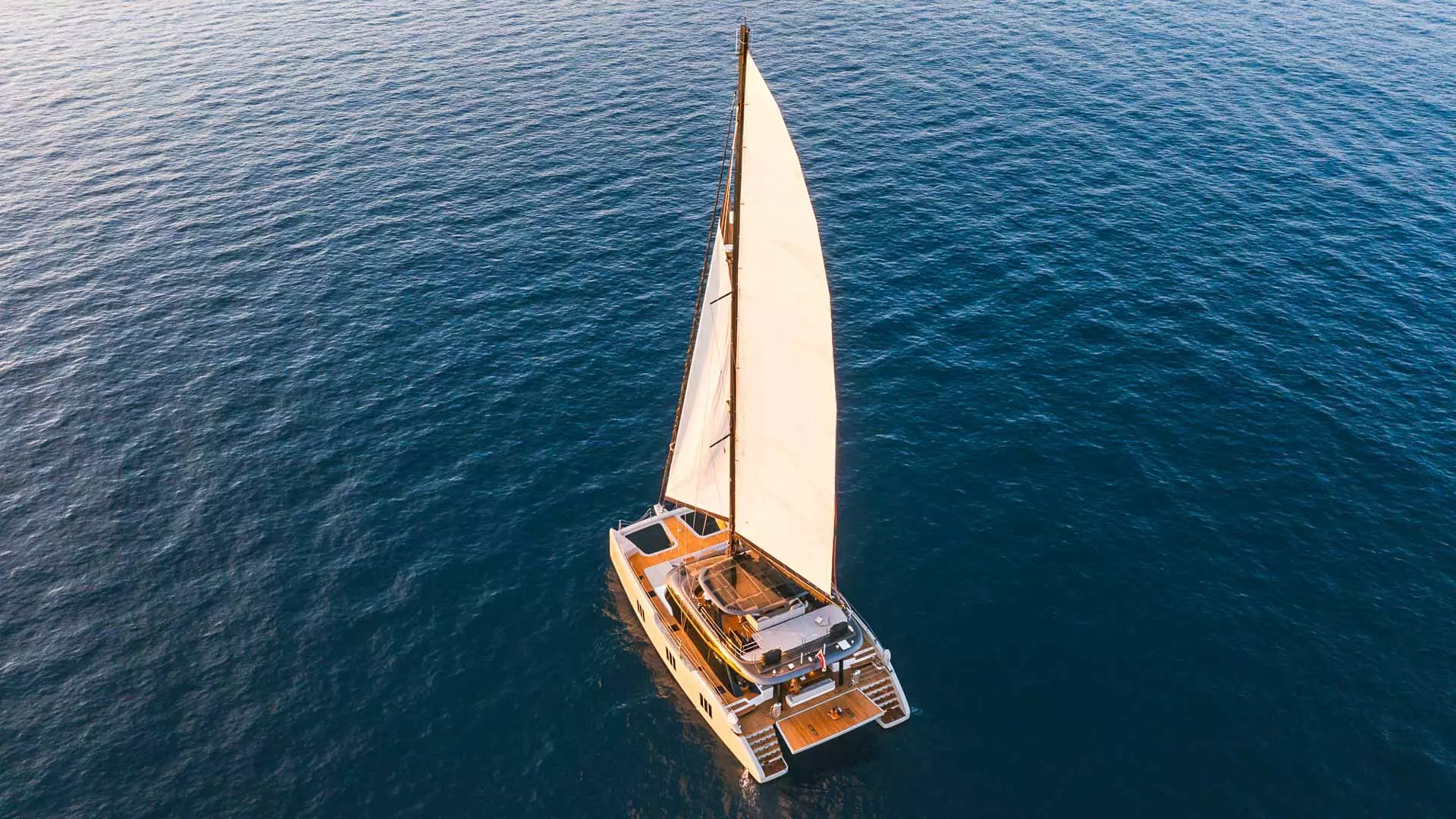 Sunreef 70 Eco Sails up aereal.jpg