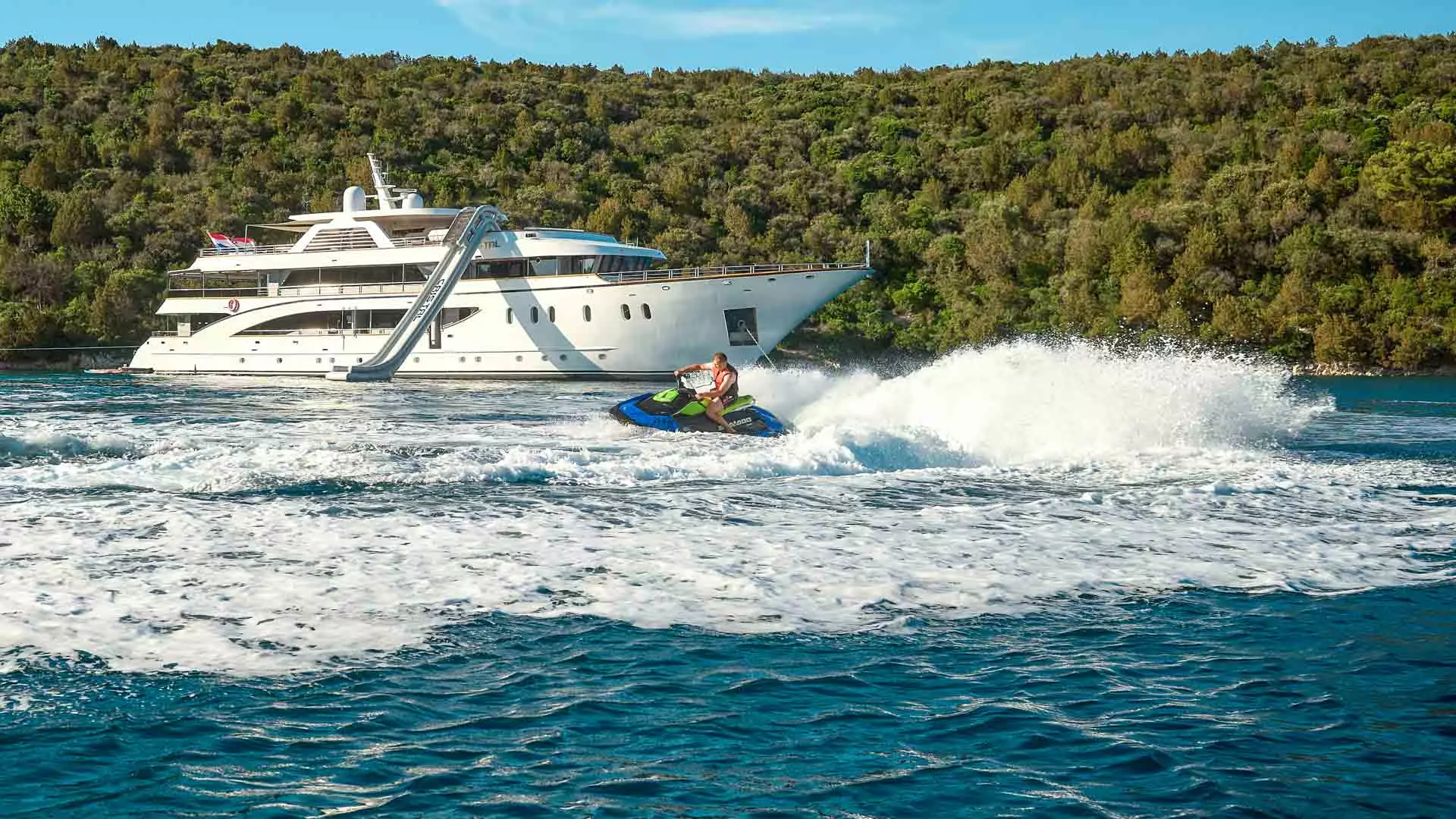 Cristal-at-anchor-with-guest-riding-jetski.jpg