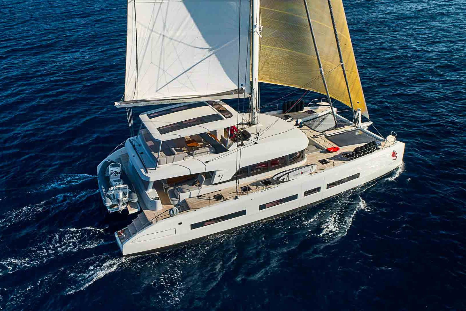 This is photo of a catamaran Lagoon 77 named Adriatic Dragon sailing side view