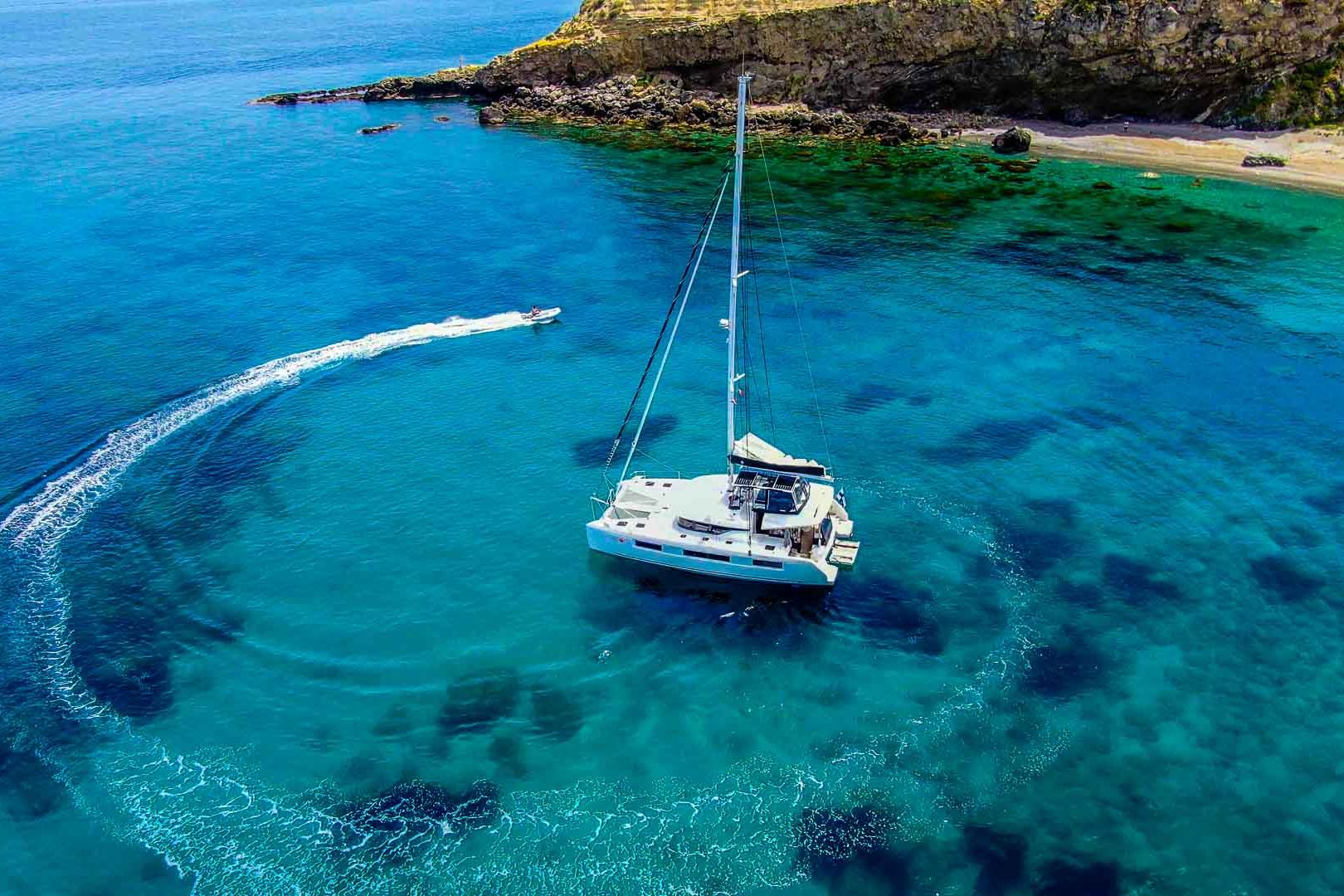 This is photo of a Lagoon 50 at anchor