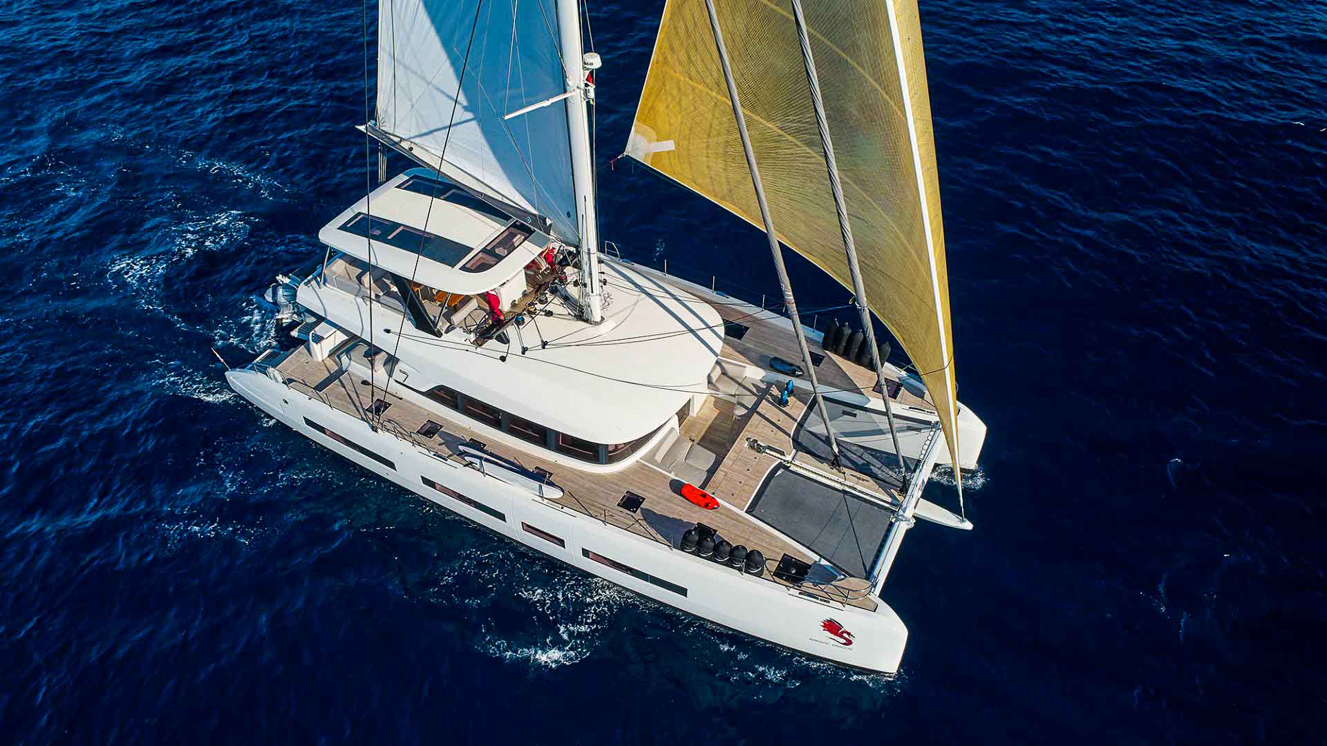 This is photo of a catamaran Lagoon 77 named Adriatic Dragon, sailing aerial view