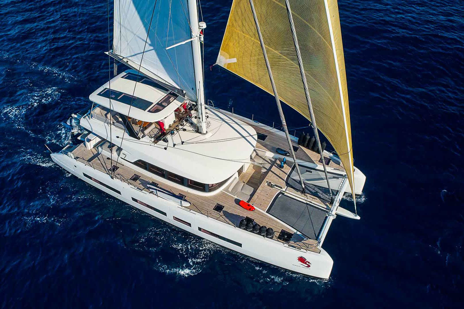 This is photo of a catamaran Lagoon 77 named Adriatic Dragon sailing, aerial view