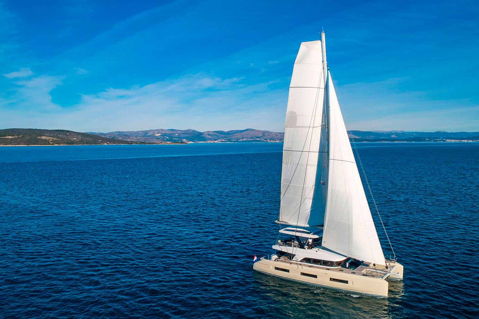 This is photo of a catamaran Lagoon Sixty5 named Amada Mia sailing