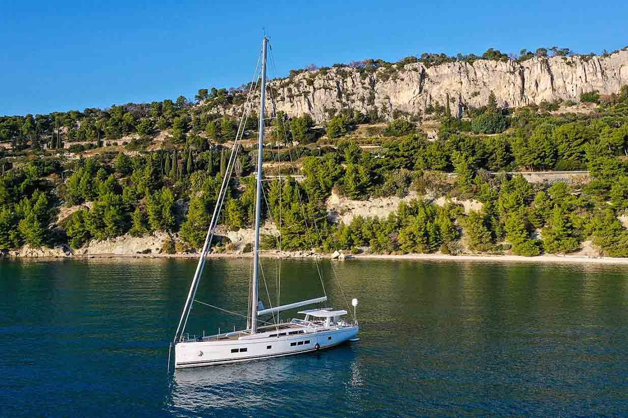 This is photo of a sailing boat Hanse 675 at anchor, aerila view