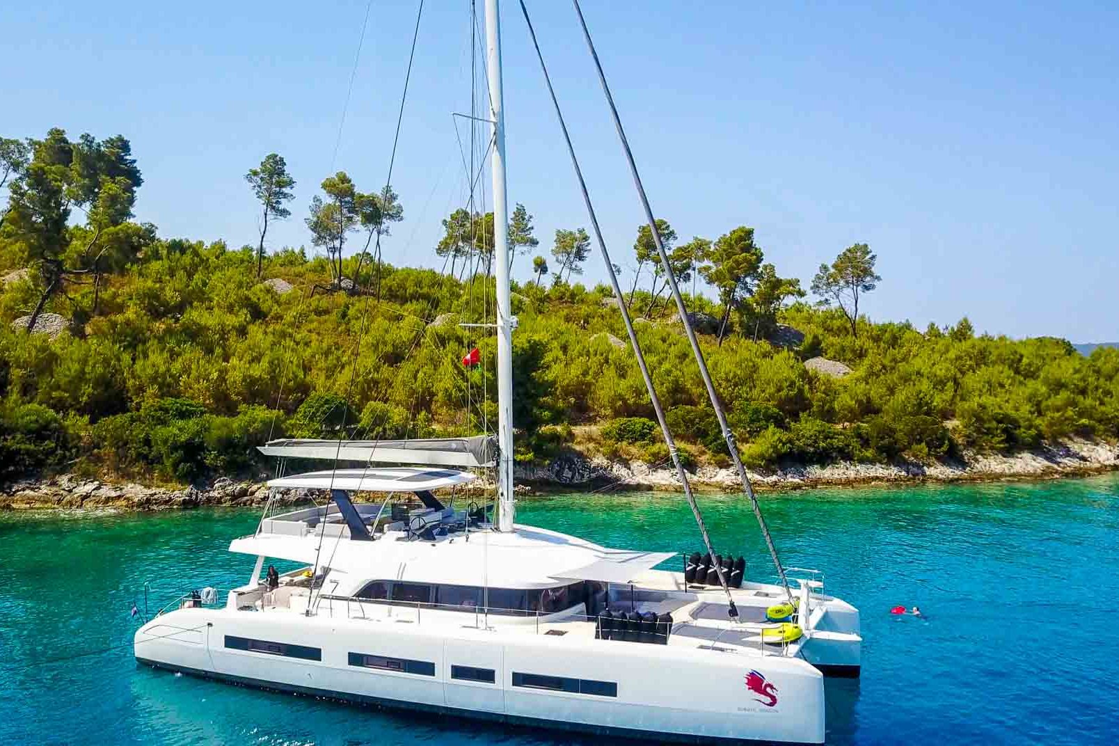 This is photo of a catamaran Lagoon 77 named Adriatic Dragon at anchor