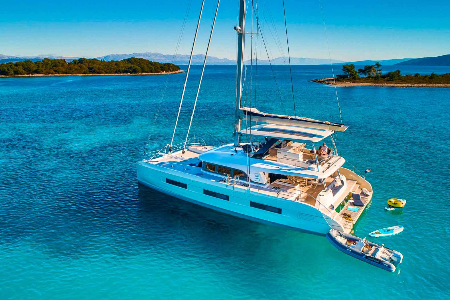 This is photo of a catamaran Lagoon Sixty5 named Amada Mia at anchor, aerila view, Adriatic Sea