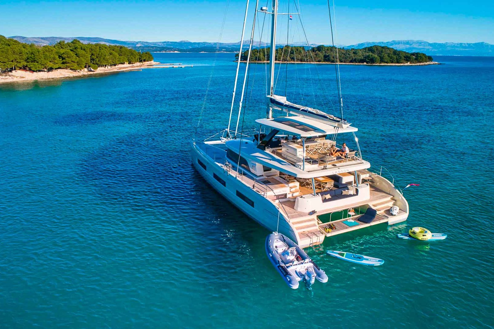 This is photo of a catamaran Lagoon Sixty5 named Amada Mia stern view with water toys