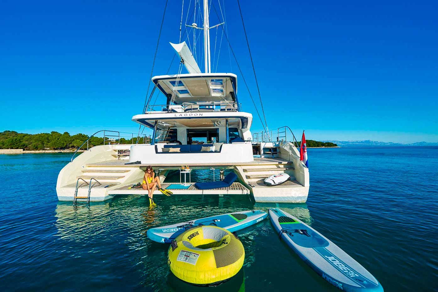 This is photo of a catamaran Lagoon Sixty5 named Amada Mia stern view and water toys