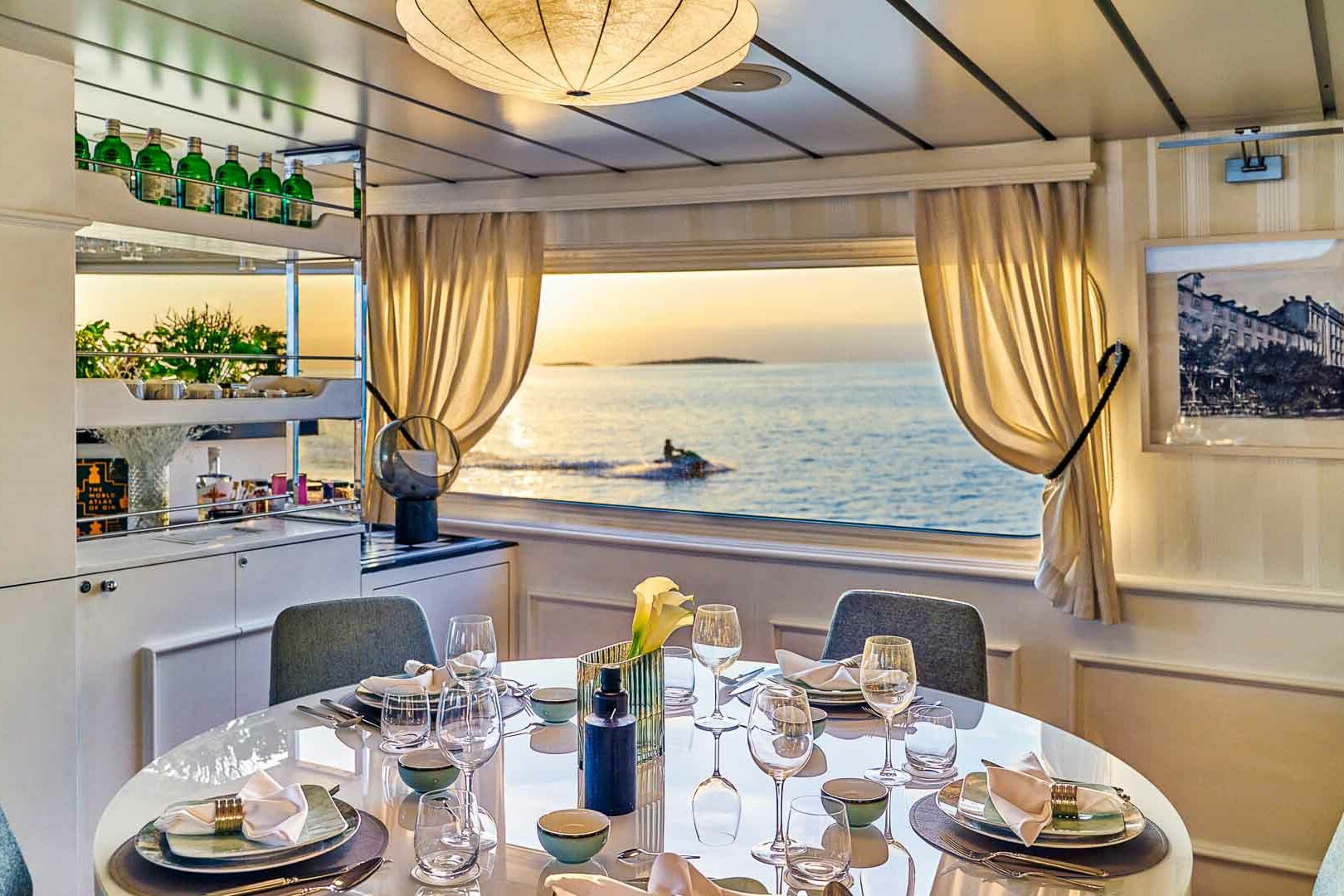 Luxury boutique yacht La Perla table in salon