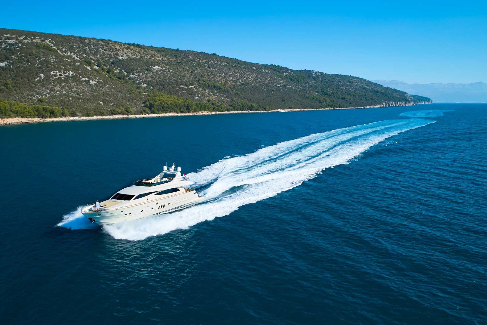 The luxury yacht Karisma running port bow view