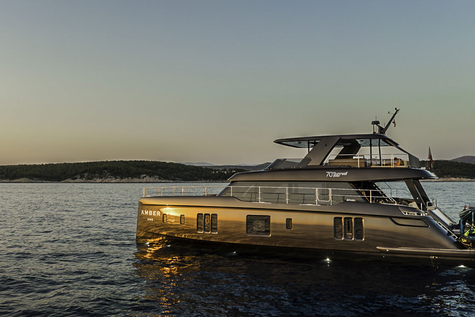 Luxury catamaran Sunreef 70 Power sailing in sunset