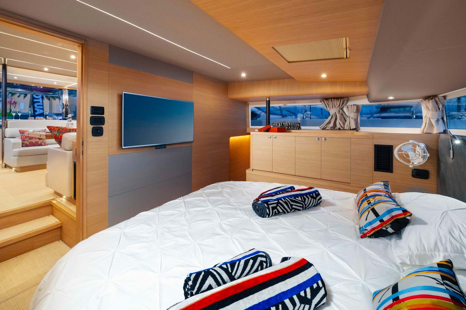 Luxury master cabin of the Aquila 54 'By my side' charter catamaran, showing a large bed and elegant furnishings.